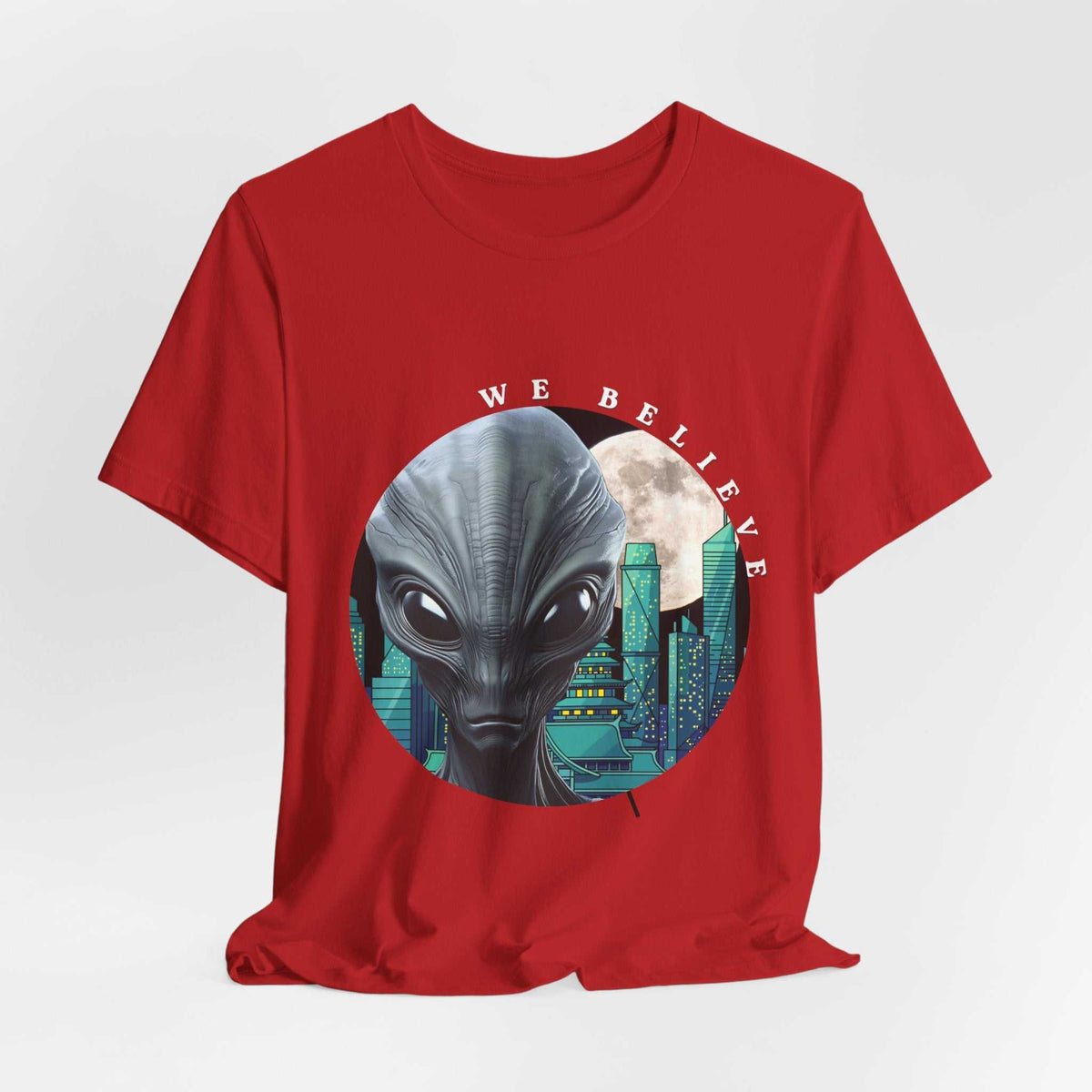 Turquoise alien graphic tee from Out of this World We Believe Collection with moon silhouette and "We Believe" text